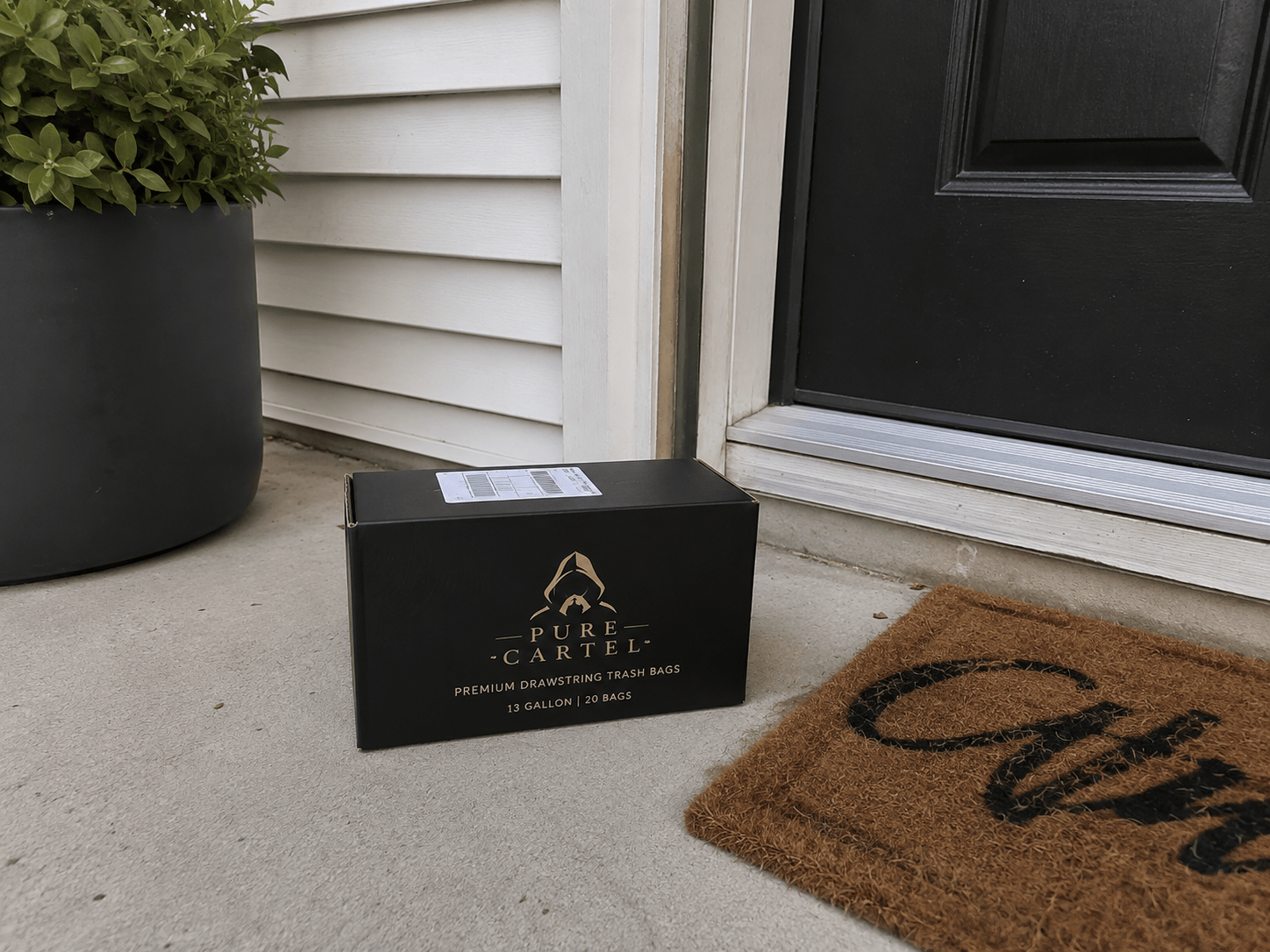 Pure Cartel box left on the side porch next to a potted plant
