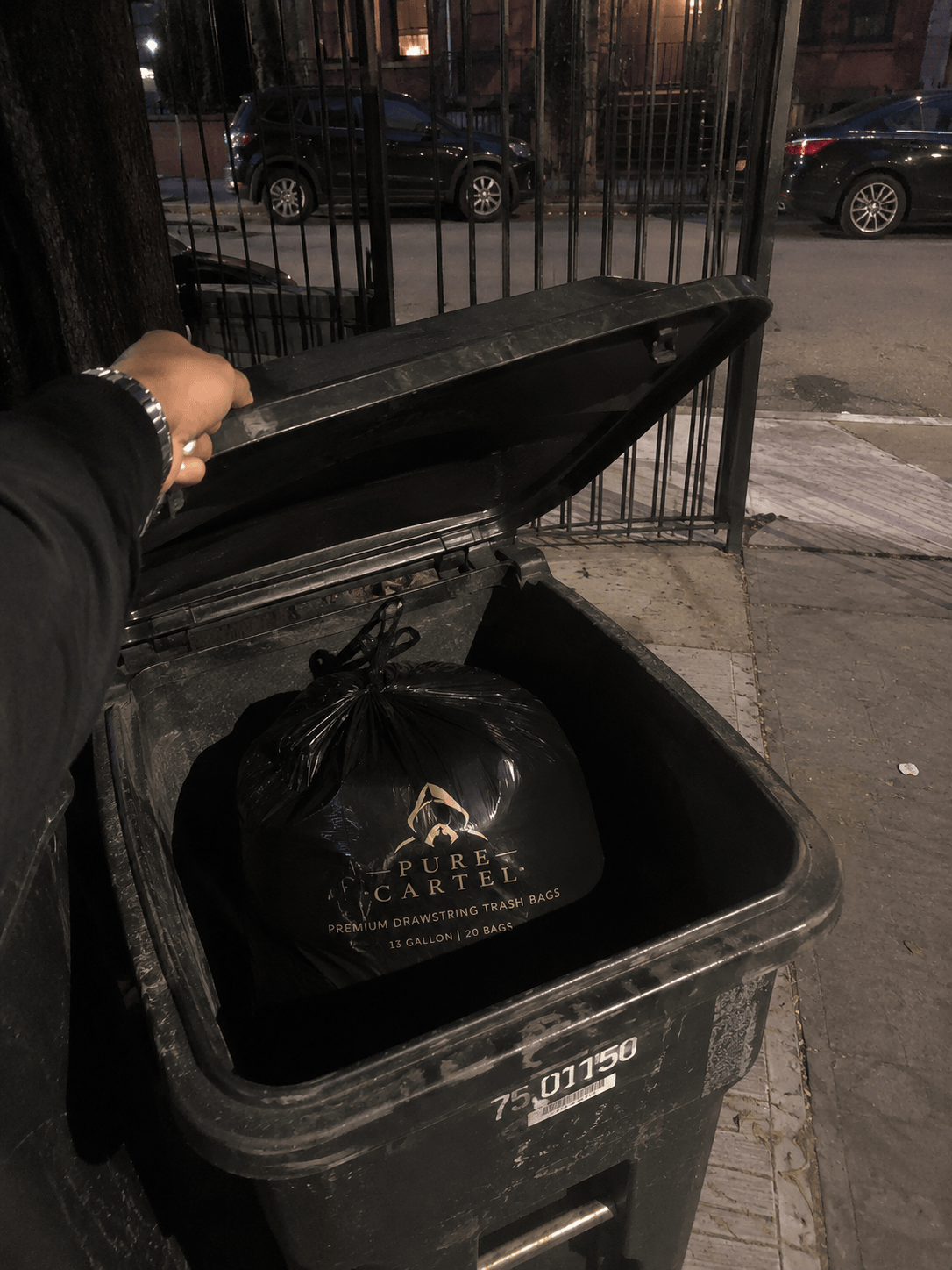 A liner holding up in an outdoor street bin at night