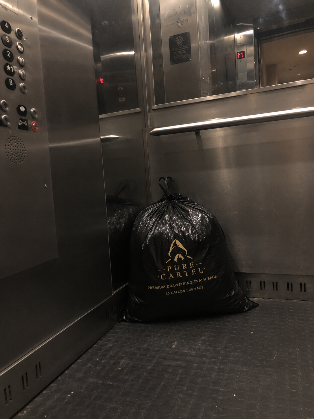 A liner standing in a brushed-steel elevator